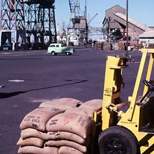 Forklift truck loading fishmeal onto a ship at Docks Walvis Bay