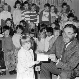 Four-year-old Emily Sylvester presents a &pound;300 cheque to National Society for