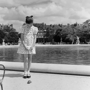 France Paris -A young girl takes her Tortoise for a walk in the park during the state of France Paris -A young girl takes her Tortoise for a walk in the park during the state of