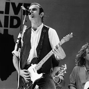 Francis Rossi lead singer with Pop Group Status Quo singing on stage at Live Aid concert
