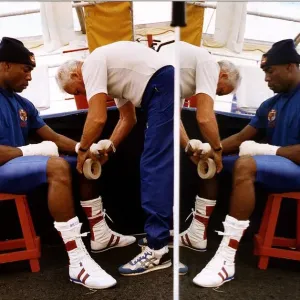 Frank Bruno Boxer sitting on stall having a bandage put on his hands