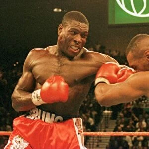 Frank Bruno lands a rare punch on Mike Tysons chin during the WBC world title fight in
