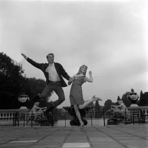 Frank Ifield singer with actress Annette Andre June 1965 jumping in the air hand Frank Ifield singer with actress Annette Andre June 1965 jumping in the air hand