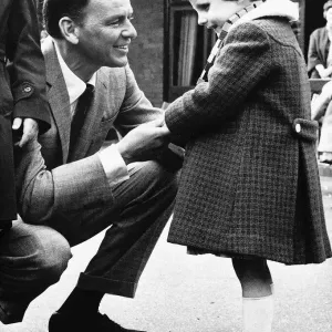 Frank Sinatra Actor and Singer talking to a little blind girl at his visit to Frank Sinatra Actor and Singer talking to a little blind girl at his visit to