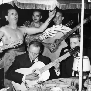 Frank Sinatra seen here playing the guitar during a gala party held by Grace Kelly in Frank Sinatra seen here playing the guitar during a gala party held by Grace Kelly in