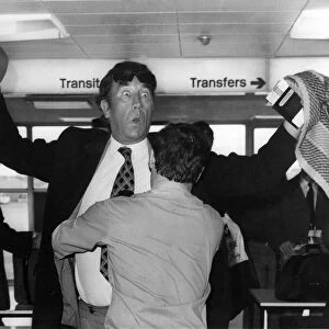 Frankie Howerd being searched by a security guard at Londons Heathrow Airport
