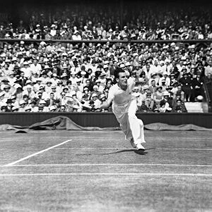 Fred Perry (GB) lunges to play a forehand at Wimbledon in the Mens semi finals again Jack