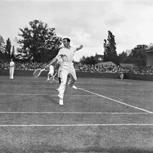 Fred Perry playing doubles lawn tennis. It is not clear as to the actual Fred Perry playing doubles lawn tennis. It is not clear as to the actual