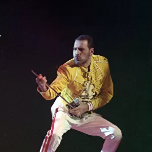 Freddie Mercury of Queen on stage, performing an air guitar. November 1989