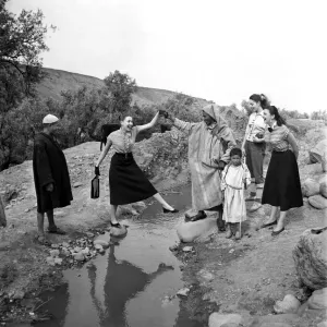 French actresses on a visit to Morroco speak to a local guide as he takes them