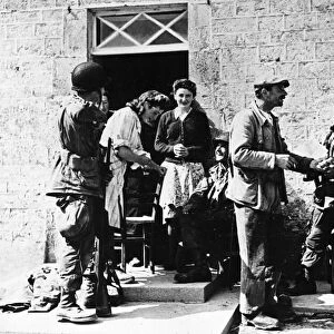 French civilians welcome American paratroopers, members of the Allied Expeditionary Force