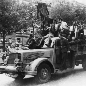 French Forces of the Interior and civilians stage a victory parade in Paris after French Forces of the Interior and civilians stage a victory parade in Paris after