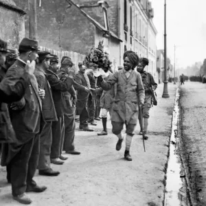 French troops shaking hands and giving floral bouquets to the Indian soldiers as they
