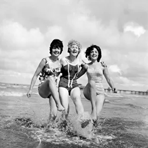 Three friends from County Durham go for a paddle in the sea at Blackpool beach in