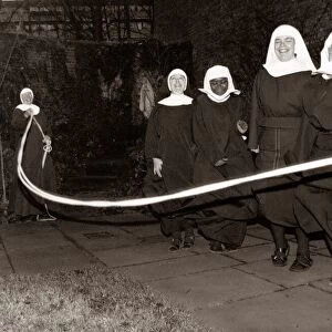 Fun loving nuns enjoying a game of skipping behind the walls of their convent
