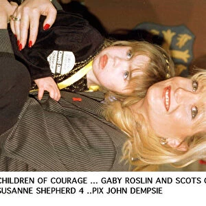 Gaby Roslin cuddles Suzanne Shephard - one of 1995 Children of courage the Ayrshire girl