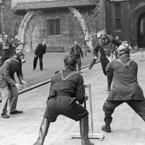 A game of cricket played in an English village by men wearing gas masks May 1941 A game of cricket played in an English village by men wearing gas masks May 1941