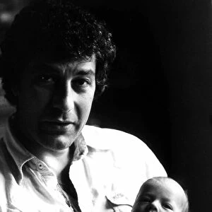 Gareth Hunt in June 1980 with 5 week old baby Oliver at their home in Effingham, Surrey