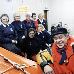 Gareth Wigmore, a RNLI crew member pictured with women who helped raise money to build a