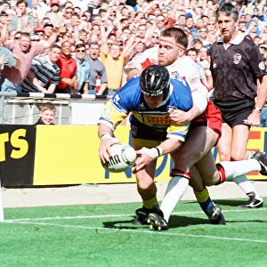 Garry Schofield avoids the Wigan defence to score a try for Leeds during the Rugby