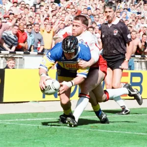 Garry Schofield avoids the Wigan defence to score a try for Leeds during the Rugby Garry Schofield avoids the Wigan defence to score a try for Leeds during the Rugby