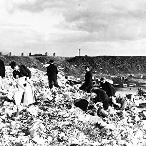 General view of unemployed workers from Cardiff picking over a rubbish tip in 1938