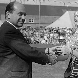 Geoffrey Rootes presenting a sash and cup to Mrs Greenway who was chosen as Miss Humber