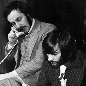 George Best and his business partner Malcolm Mooney working at Bests home