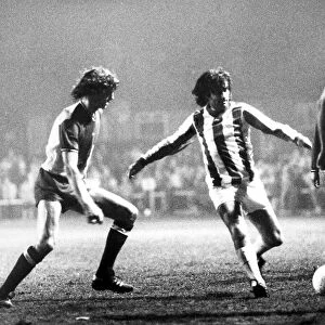 George Best dribbles the ball between Coventry defenders Garry Gillespie(left
