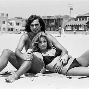 George Best at Hermosa Beach, Los Angeles, California, with his new girlfriend Heidi