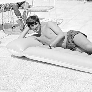 George Best relaxing on an inflatable bed whilst on holiday April 1967