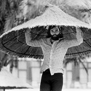 George Best with a over sized straw hat Circa 1974