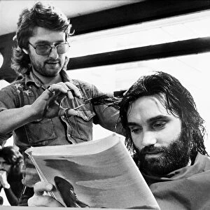 George Bests reads the paper whilst having his haircut May 1974