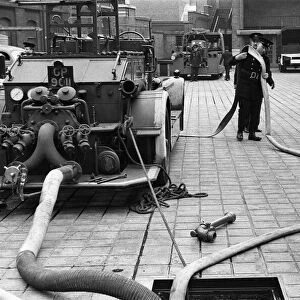 George Greenwell carrying hose with Station Officer Harding seen here during pump
