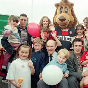 George Hardwick, Bernie Slaven and Roary the Boro mascot surrounded by fans at