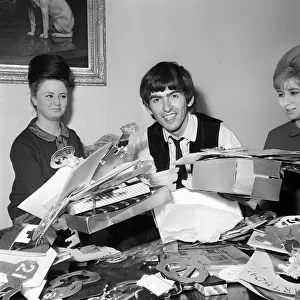 George Harrison, 21st birthday, with fan-club secretary Anne Collingham helping him sort