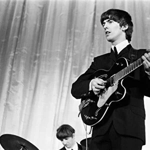 George Harrison of the Beatles seen here on stage November 1964