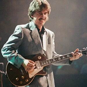 George Harrison ex Beatles Playing the guitar at the Gary Moore concert at the Royal