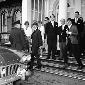 George Harrison and Paul McCartney of The Beatles leaving the Imperial Hotel