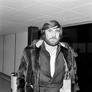George Lazenby arrived at Heathrow Airport today from San Francisco