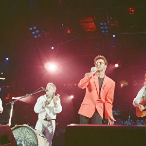 George Michael and the 3 remaining members of Queen perform the song "39"