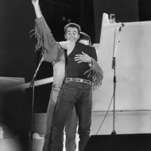 George Michael and Andrew Ridgley (left) of pop duo Wham! on stage for the final embrace