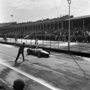 German driver Wolfgang Taffy'von Trips taking his Ferrari Dino 156 car past