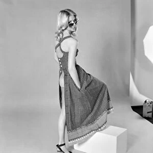 German glamour model Maureen wearing a sleeveless open backdress. April 1975