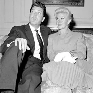 Ginger Rogers with David Hughes sitting on a couch May 1959