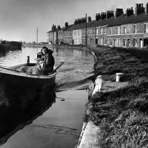 Print of a girl and her dog on a boat near Ormskirk, January 1974 Print of a girl and her dog on a boat near Ormskirk, January 1974