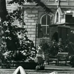 A girl sunbathes in St. Johns churchyard in Newcastle during the long hot summer in
