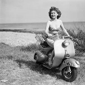 A girl on a Vespa motor scooter. 1952