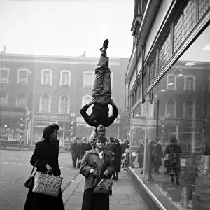 Two girls from the Chaludis act perform in the street at Hammersmith, London
