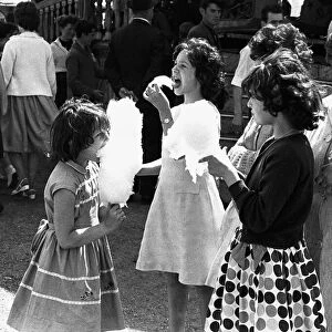 Girls eating candyfloss at Hearsall Common fair, Coventry. 3rd June 1967